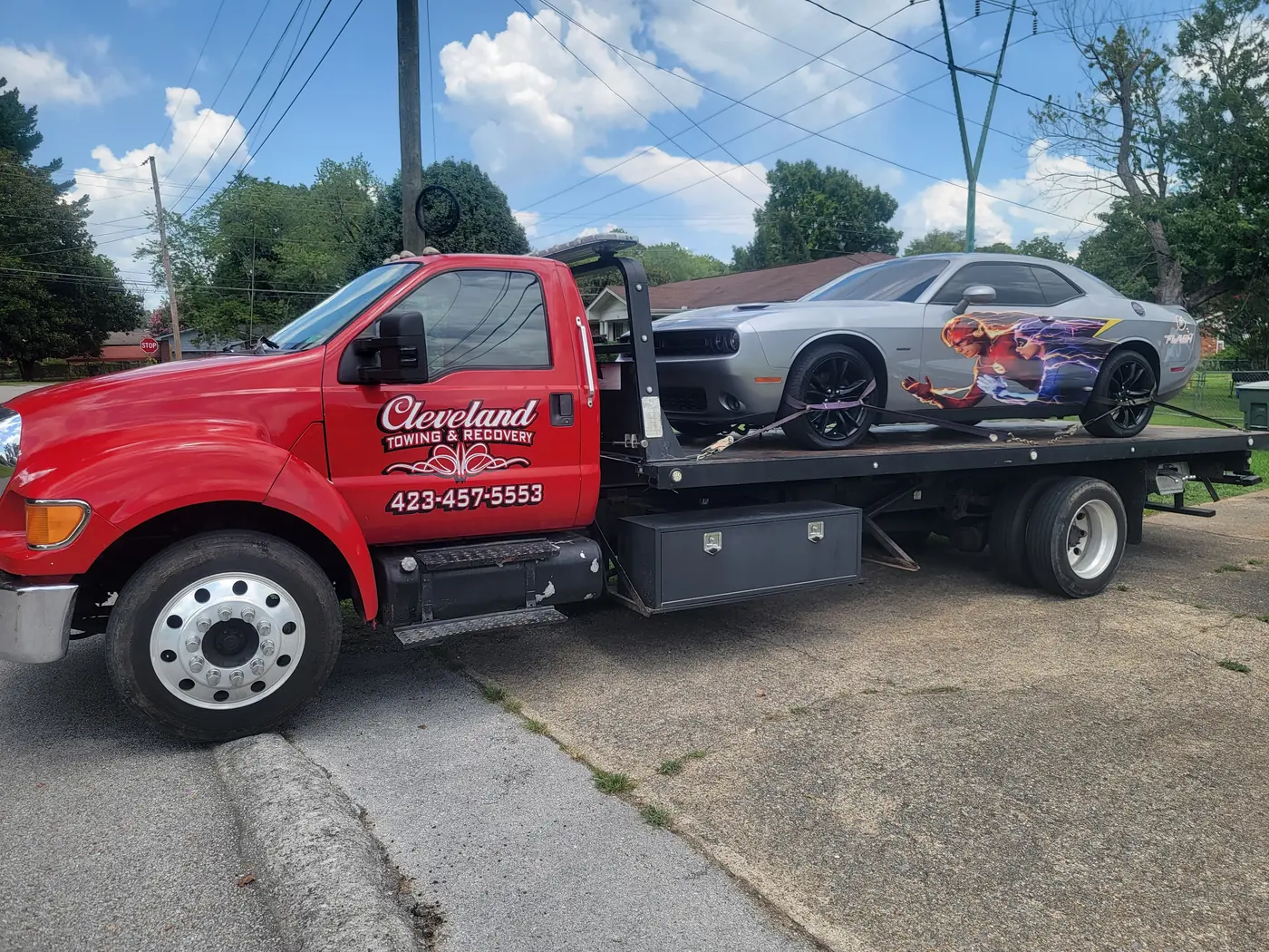 A muscle car on the deck, all four wheels off the road