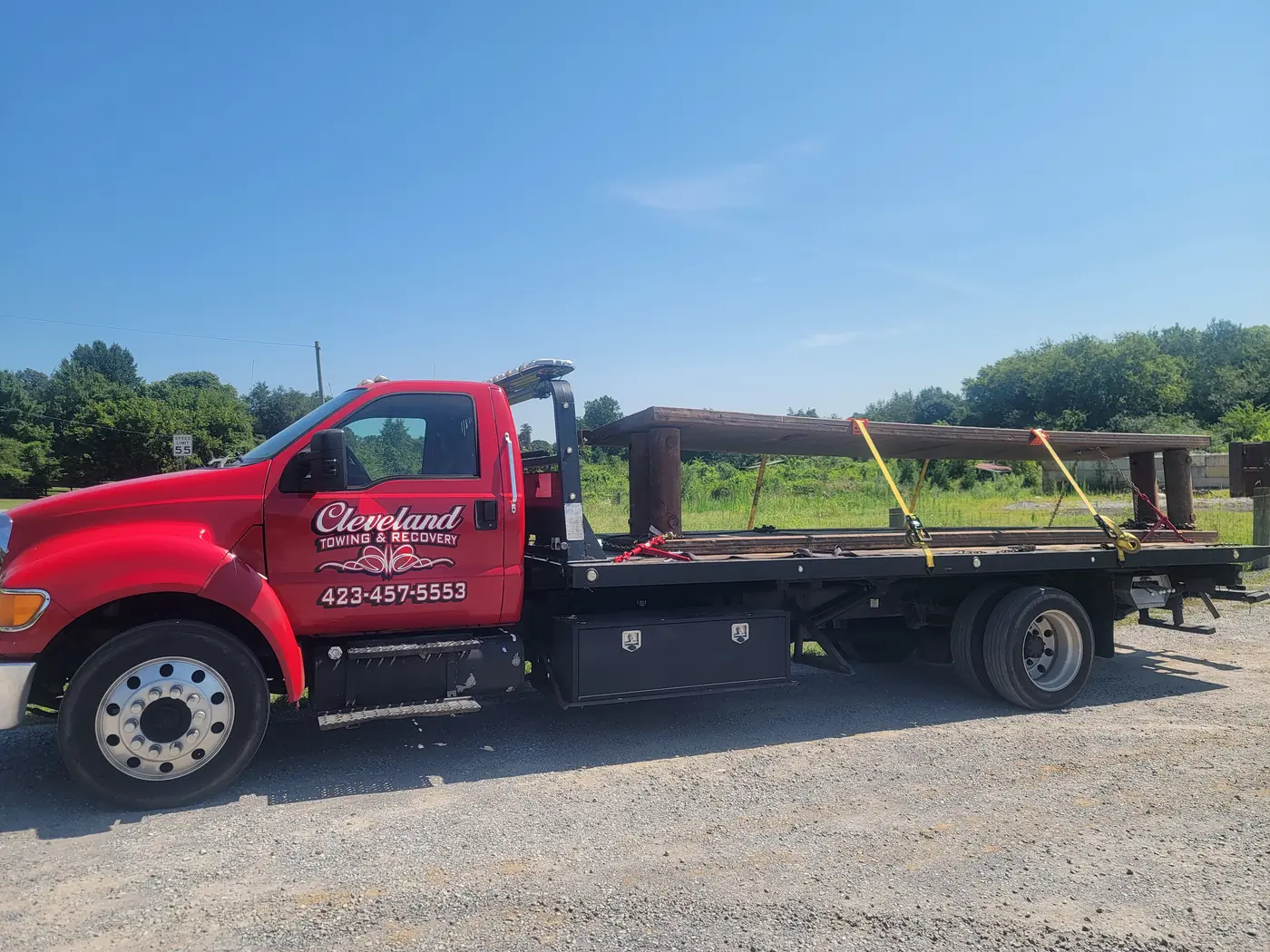 Structural steel beams loaded and strapped down on the rollback